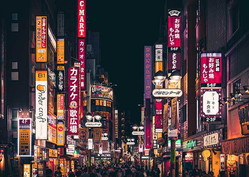 A close up of a busy city street with Kabukichō, Tokyo in the background